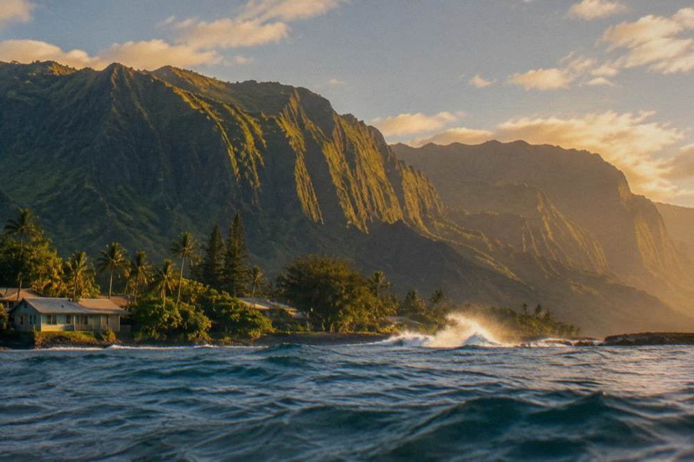 Golden evening light striking the ridged cliffs above the ocean