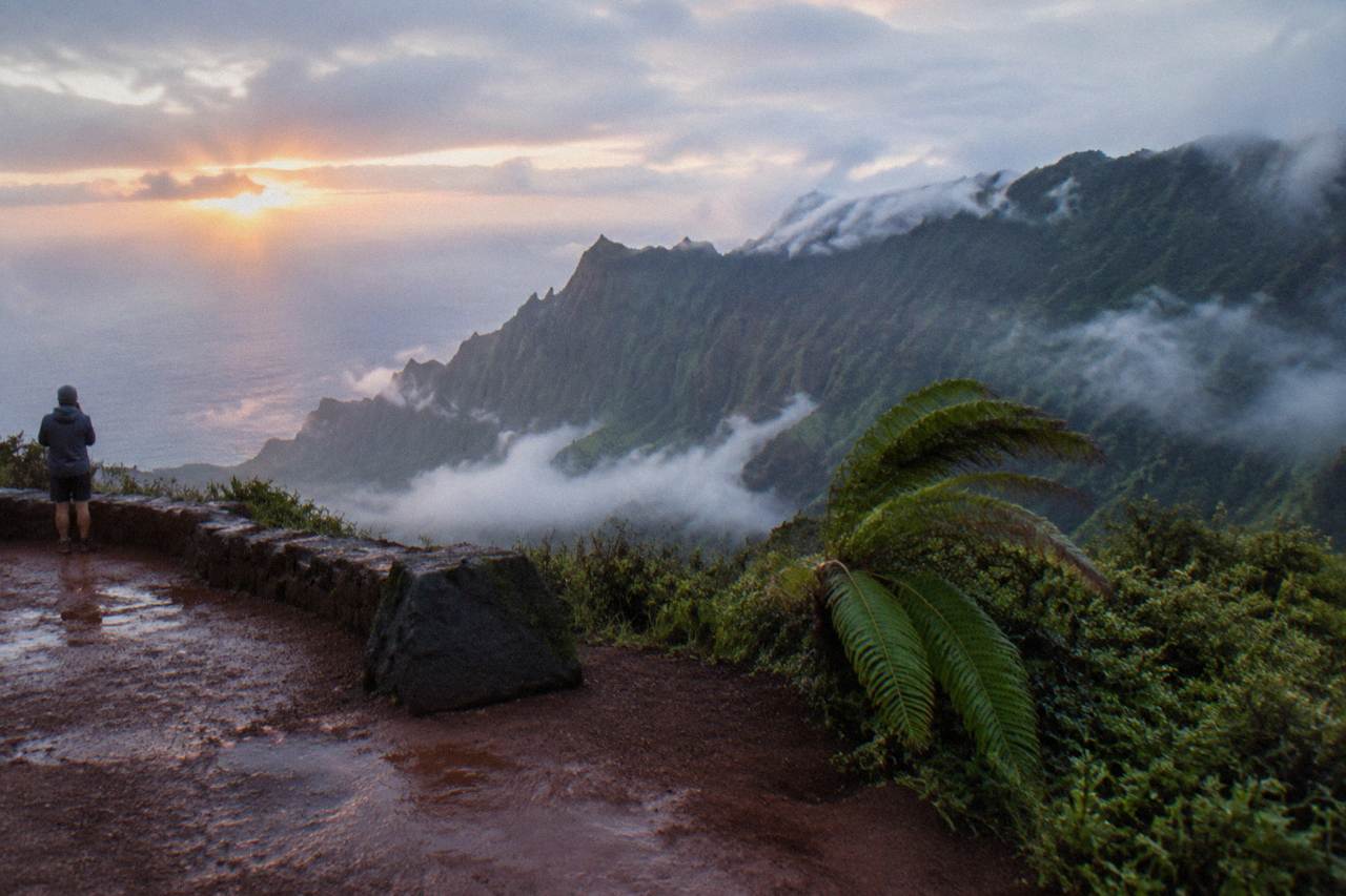 Ridgelines of the Na Pali coast rising above morning mist on Kauai