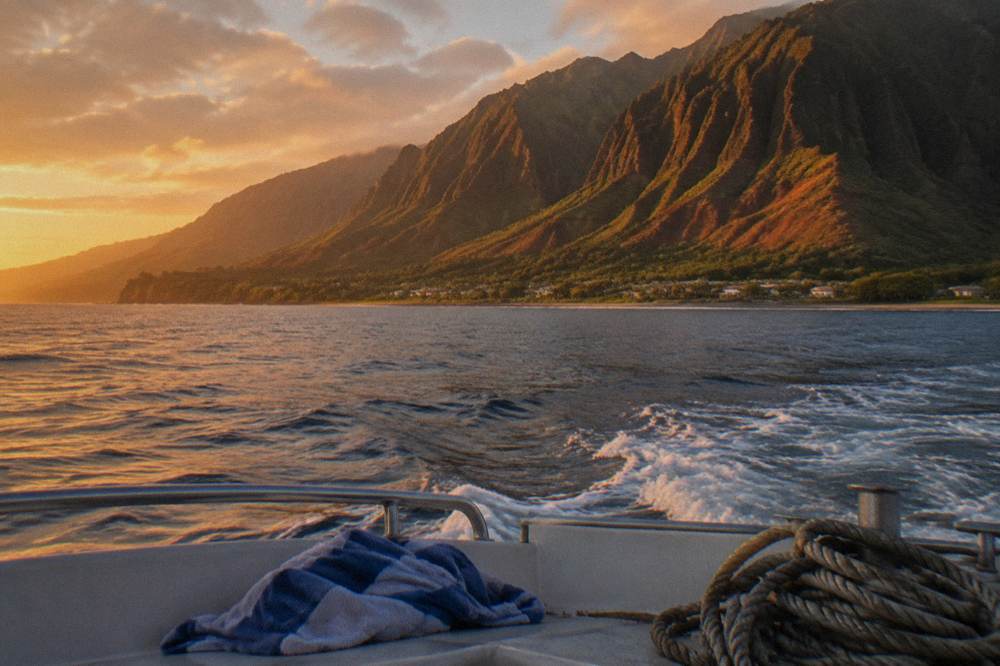 Sunset light on steep coastal ridges seen from open water