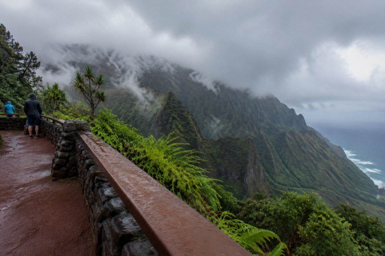 Rain clouds passing over green ridges above a Kauai valley