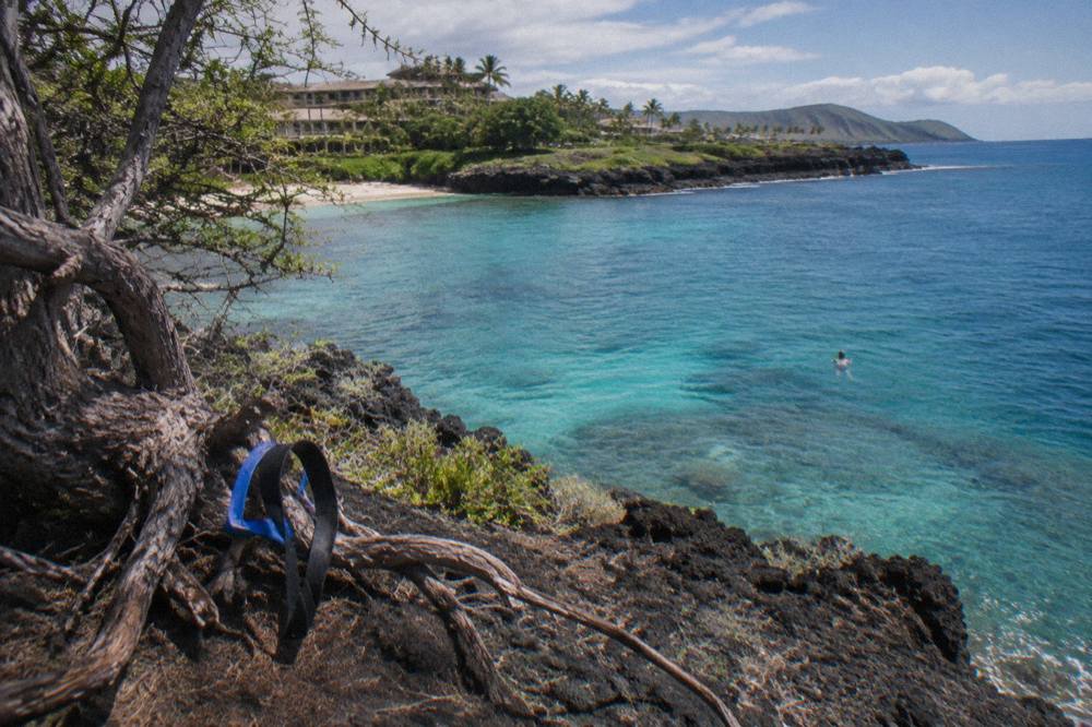 A calm south shore bay with reef water shifting from turquoise to deep blue