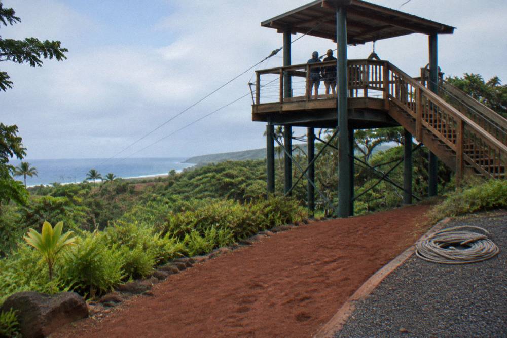 A zipline platform above a green forest canopy on Kauai's south shore