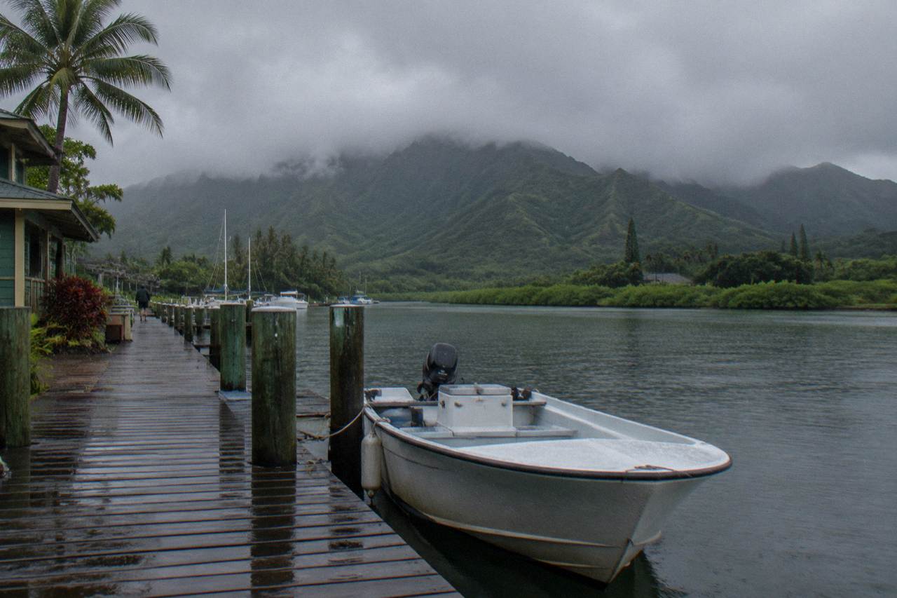 Rain clouds passing over green Kauai ridges above a tropical valley.