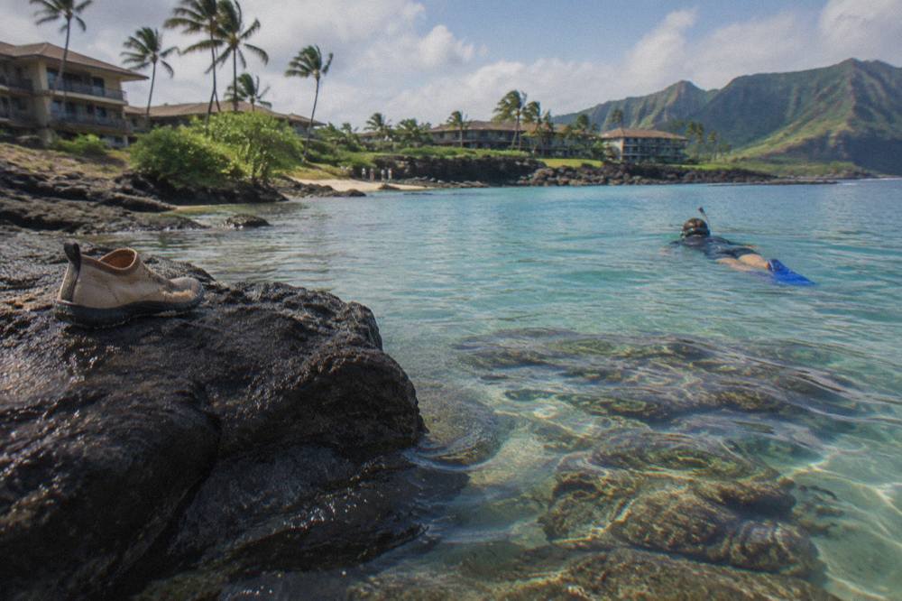 Calm turquoise bay with coral formations visible through clear water near the shore